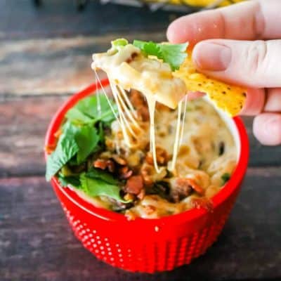 Bacon & Caramelized Onion Queso Fundido is like a gooey, cheesy bowl of everything that makes food awesome! Get ready to share, no one can resist this dip!