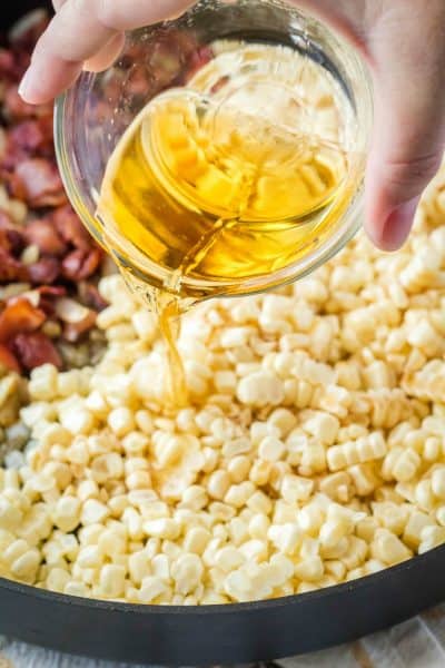 whiskey being poured into fried corn