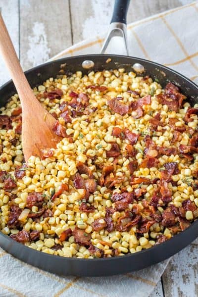 fried corn with bacon in a skillet