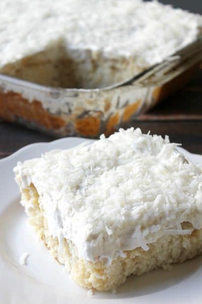 My Mom's Best Ever Coconut Cake is dessert heaven! Creamy, dreamy, tender cake topped with whipped cream is so easy to make and is loaded with coconut flavor!