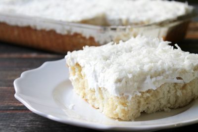 My Mom's Best Ever Coconut Cake is dessert heaven! Creamy, dreamy, tender cake topped with whipped cream is so easy to make and is loaded with coconut flavor!