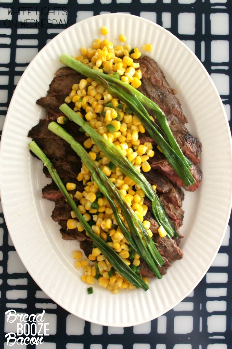 Flank Steak with Wilted Scallions and Corn Salsa is a killer family style summer dinner that will make everyone bow down to your steak skills!