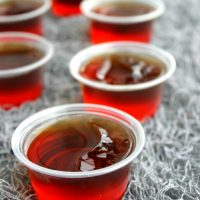 Dracula's Bite Jello Shots are a spiked cherry coke cocktail turned into Halloween party must make!