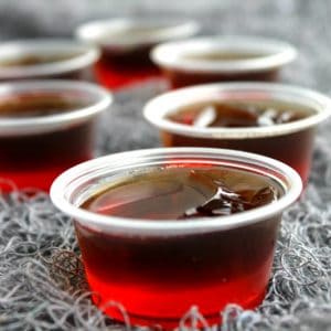 Dracula's Bite Jello Shots are a spiked cherry coke cocktail turned into Halloween party must make!