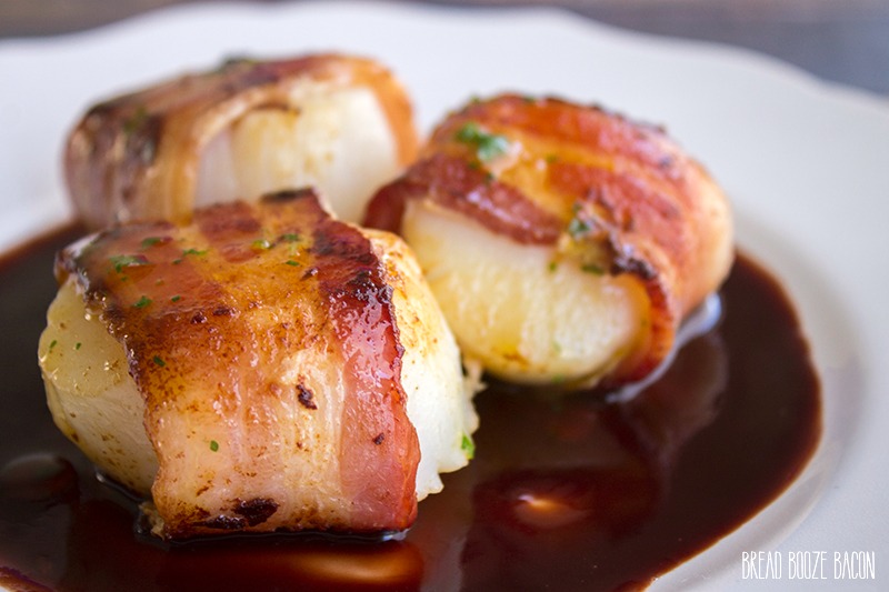 Bacon Wrapped Scallops Recipe with Pomegranate Sauce are a succulent dish that's fancy enough for a dinner party, or serve them family style for your friends!