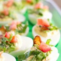 BLT Deviled Eggs are a poppable party bite loaded with bacon, lettuce, and tomato! Who needs a sandwich when you can have deviled eggs!