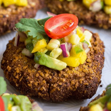 Spice up your meal with Mexican inspired Black Bean Cakes with Corn-Mango Salsa! These crispy cakes are delicious, easy to make, and topped with a fresh salsa that'll make your taste buds dance!