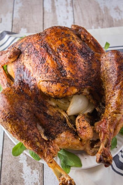 roasted thanksgiving turkey on a serving platter with sage