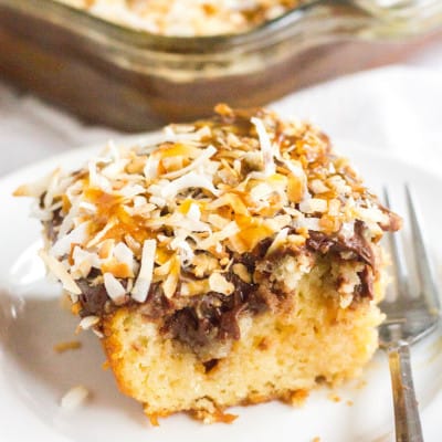This Girl Scout cookie-inspired Samoa Poke Cake is a decadent dessert that'll have you craving all things chocolate, caramel, and coconut!