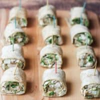 Easy Chicken Caesar Salad Pinwheels with toothpicks lined up on a cutting board