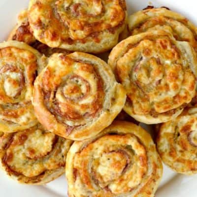 Cheesy French Pinwheels piled up on a plate
