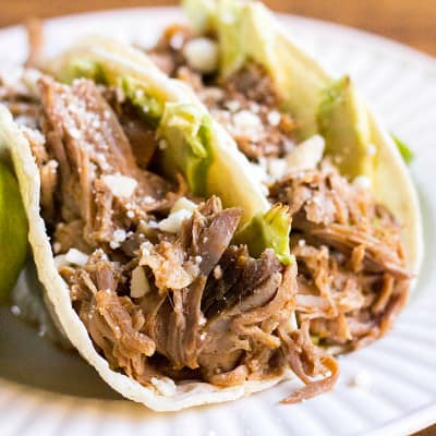 Cuervo & Tecate Slow Cooker Carnitas recipe is packed with so much flavor. This Mexican-style pork is super easy to make and perfect for Taco Tuesday!