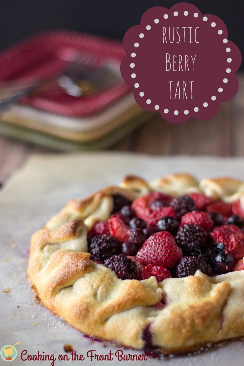 angled view of rustic berry tart on parchment paper