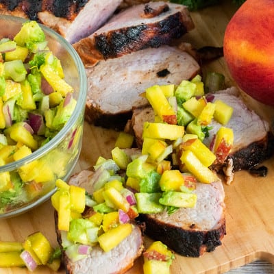 Grilled Pork Tenderloin with Avocado Peach Salsa is bursting with flavor! This easy grilling recipe will leave a smile on your face and full bellies all around!