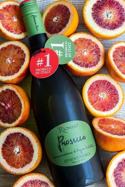 riondo prosecco bottle surrounded by blood orange halves