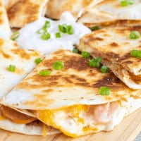 Cheesy and meaty, this easy Chipotle Polish Sausage Quesadilla is a hit with the whole family! Loaded with polish sausage, cabbage, bacon, and cheese each bite begs to be dipped in chipotle sour cream!