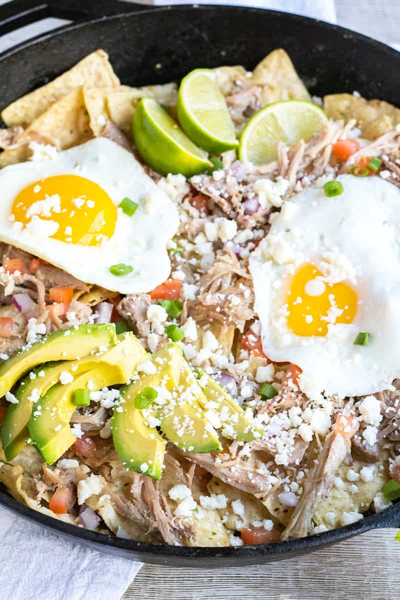 cast iron skillet filled with Pork Chilaquiles with eggs