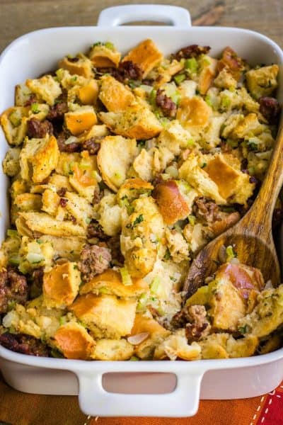 sausage stuffing in a baking dish with a serving spoon