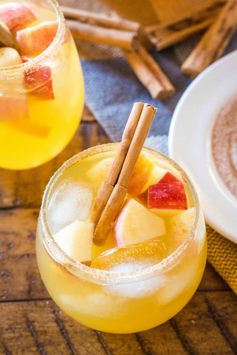 close up of apple cider sangria with apple and cinnamon stick garnish