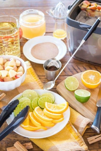 ingredients and OXO bar tools to make apple cider sangria