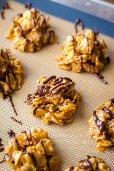 cornflake cookies on a baking sheet, drizzled with chocolate