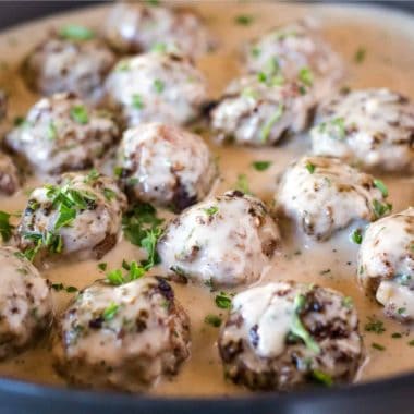 Swedish Meatballs are seriously so good! The meatballs are studded with pops of onion and then smothered in a beefy, creamy sauce for a flavor you'll crave!