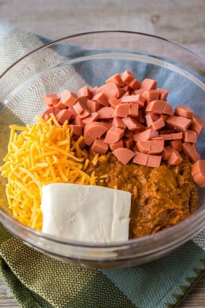 ingredients to make chili cheese dog dip in a mixing bowl