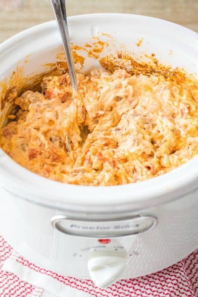 meat lover's crock pot pizza dip with a spoon