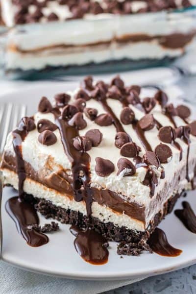 slice of chocolate lasagna topped with chocolate sauce