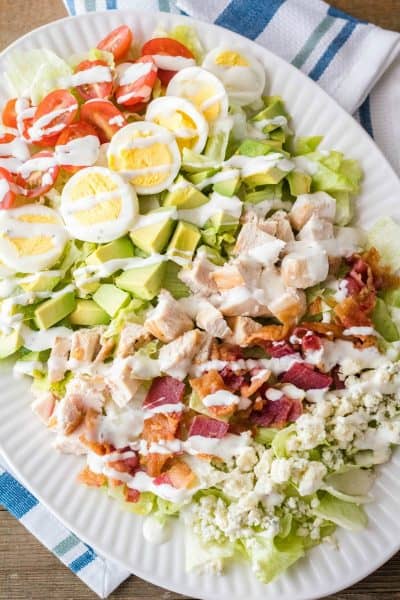 cobb salad with ranch dressing drizzled over top