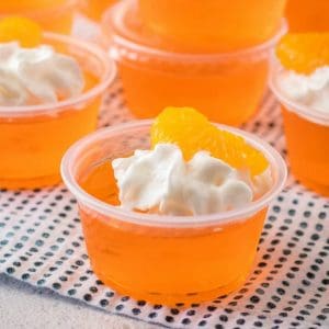 Creamsicle Orange Jello Shots are a delicious combination of fruity orange jello and creamy whipped vodka for a perfect party shot!