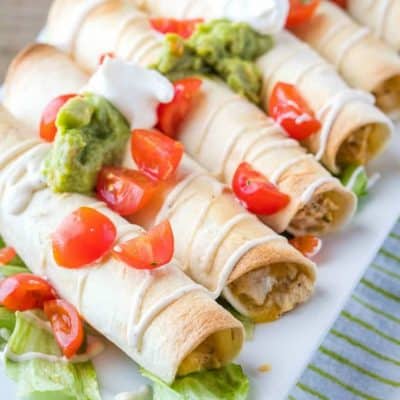 Get dinner on the table in a hurry with Creamy Baked Chicken Flautas! Cheesy chicken filling is loaded with Mexican spices for a family dinner favorite!