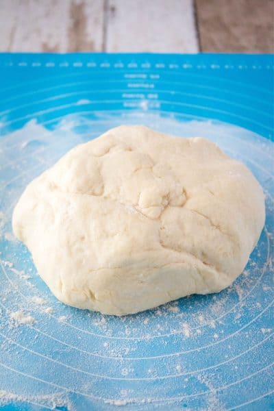 pizza dough on a lightly floured surface