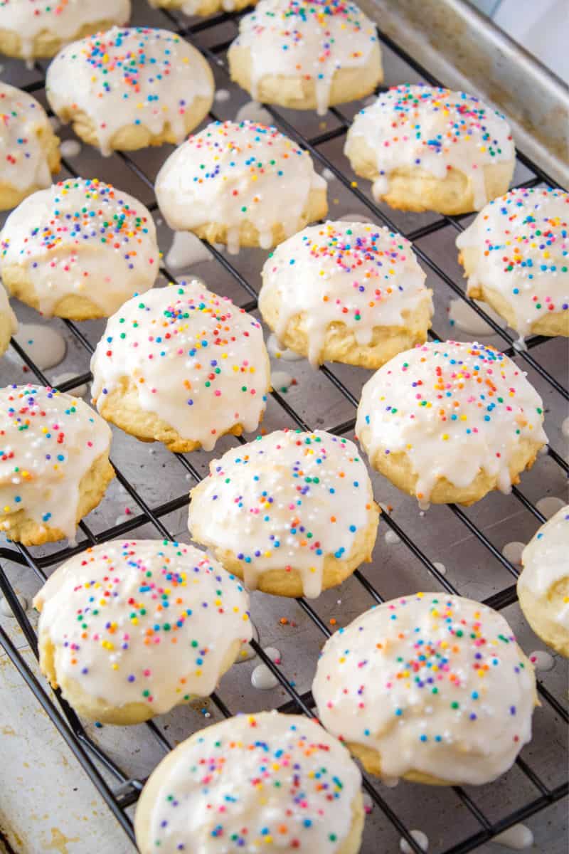 cookies dipped in glaze and topped with sprinkles on a wire rack