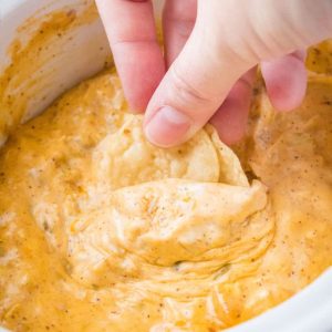 Crock Pot Chicken Queso Dip is a cheese lover's dream! Savory spices, green chiles, and chicken make this creamy, cheesy dip one for the recipe book!