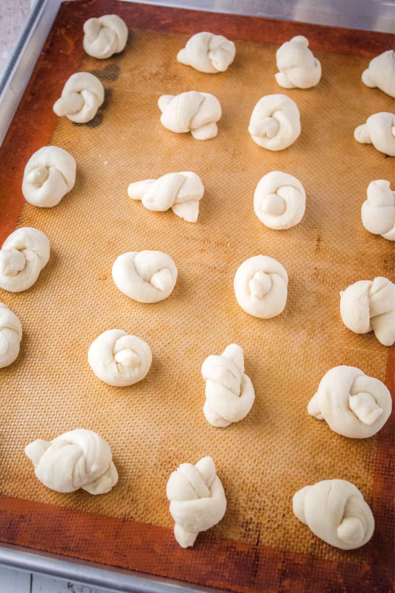 dough knots on a baking sheet before cooking