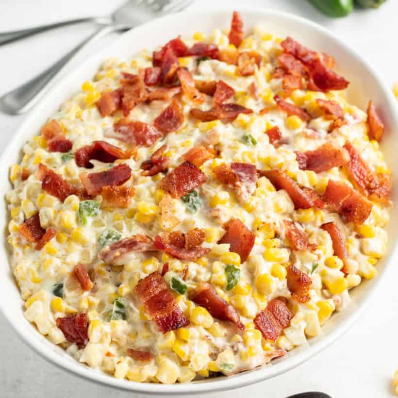 serving bowl of creamed corn topped with chopped bacon