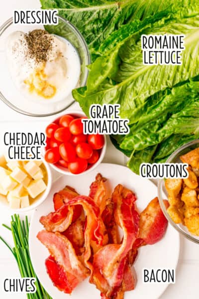 ingredients to make BLT salad laid out on a counter with text overlay
