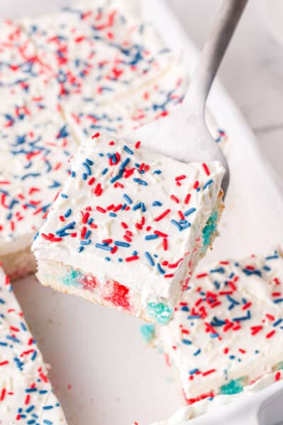 slice of 4th of july cak on a spatula over the baking dish