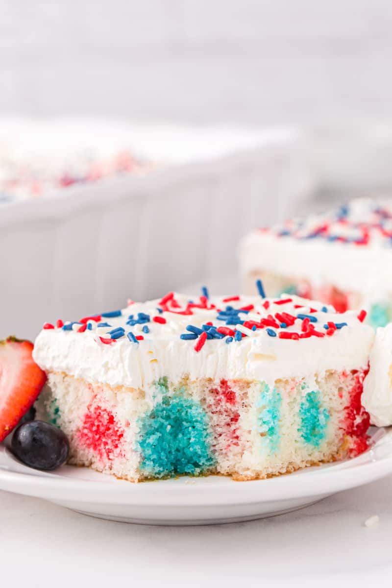 slice of fourth of july poke cake with a bite taken out