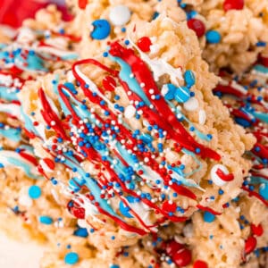 square close up image of a 4th of july rice krispie treat on a plate of treats