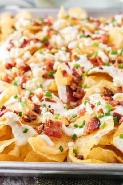 side view of potato chip nachos showing blue cheese, bacon, and chives
