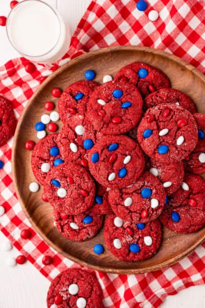 platter of red velvet cookies next to glass of milk