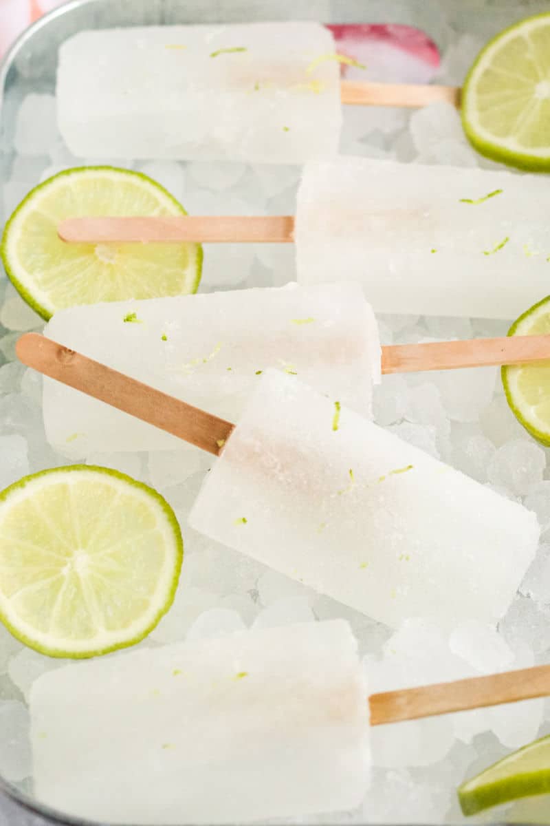limeade popsicles and lime slices on a bed of ice