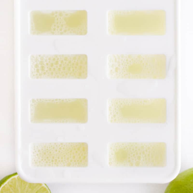 limeade mixture poured into popsicle molds