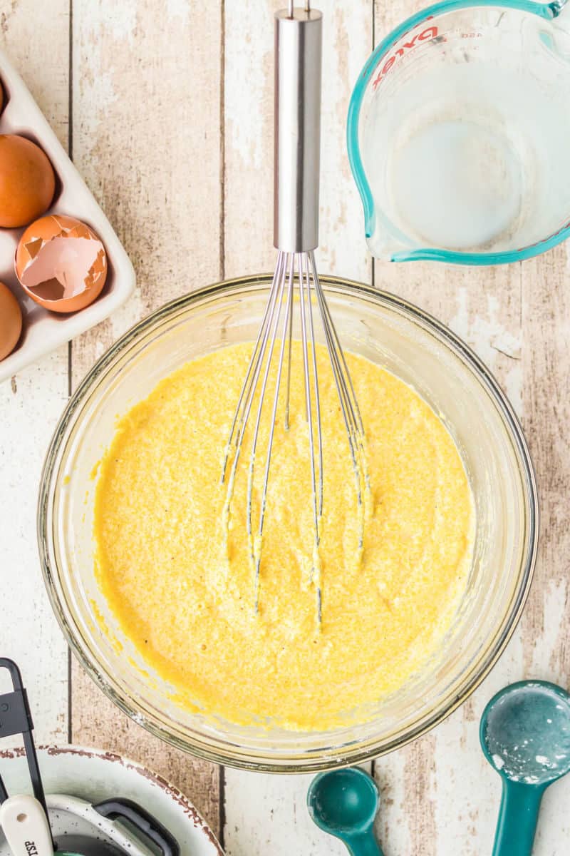 cornbread batter in a bowl with a whisk