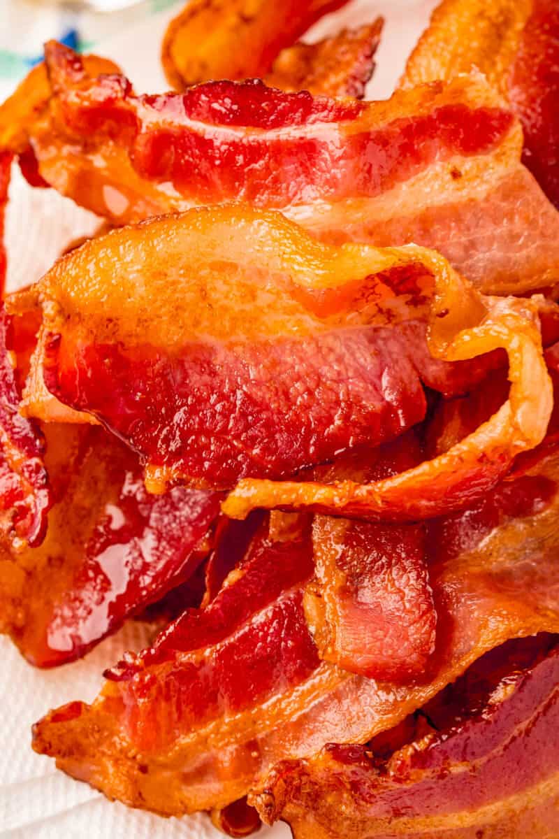 close up of air fryer bacon piled up on a plate