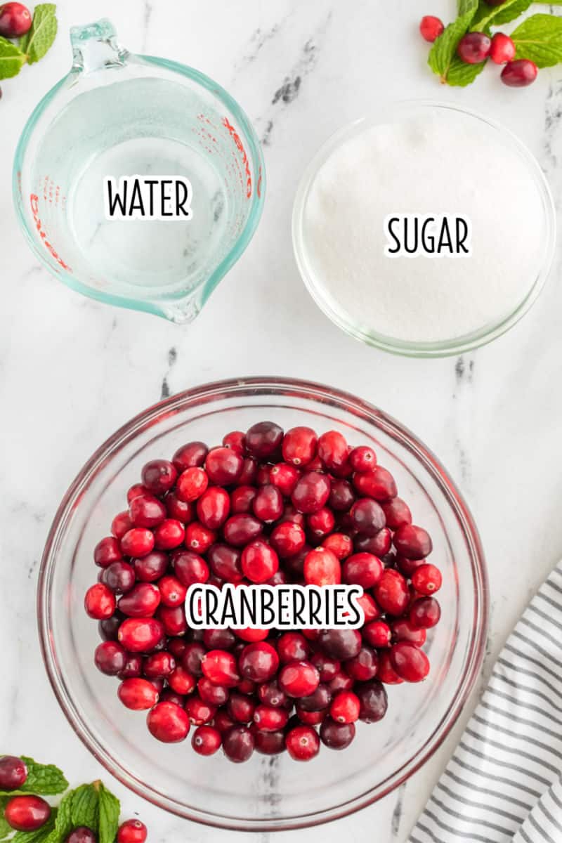ingredients to make cranberry sauce in bowls with text lables