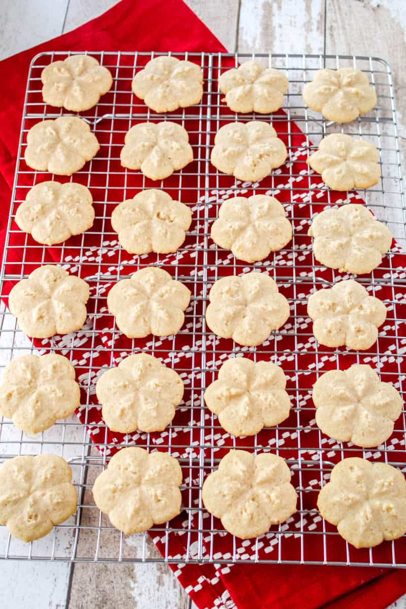 cinnamon spritz cookies on a wire cooling rack