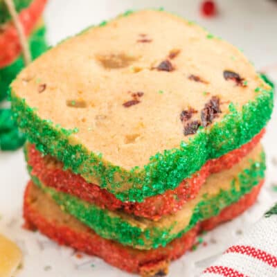 square image of four cranberry orange icebox cookies stacked up with alternating sugar colors